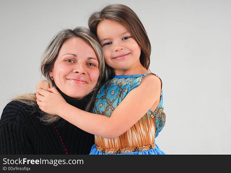 Little cute baby girl embracing her loving mom. Little cute baby girl embracing her loving mom