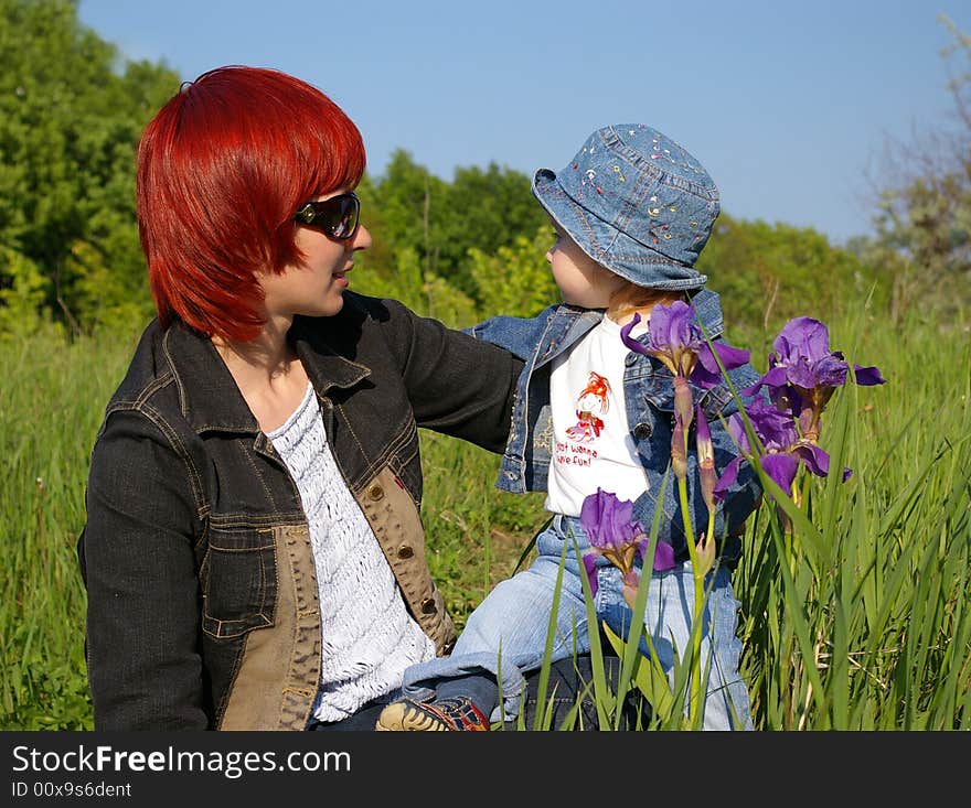 The little girl and her mum on a grass. The little girl and her mum on a grass