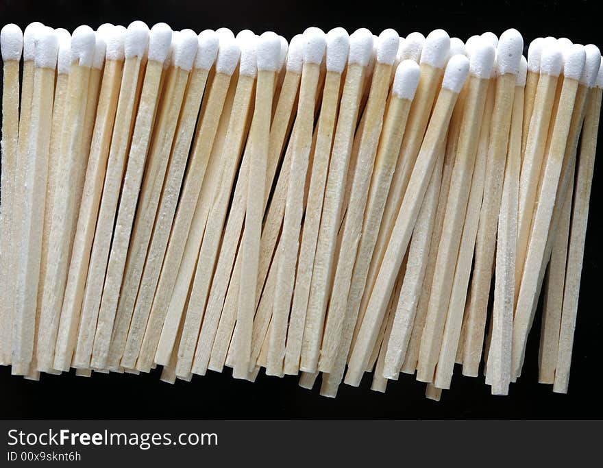 A row of matches on black background