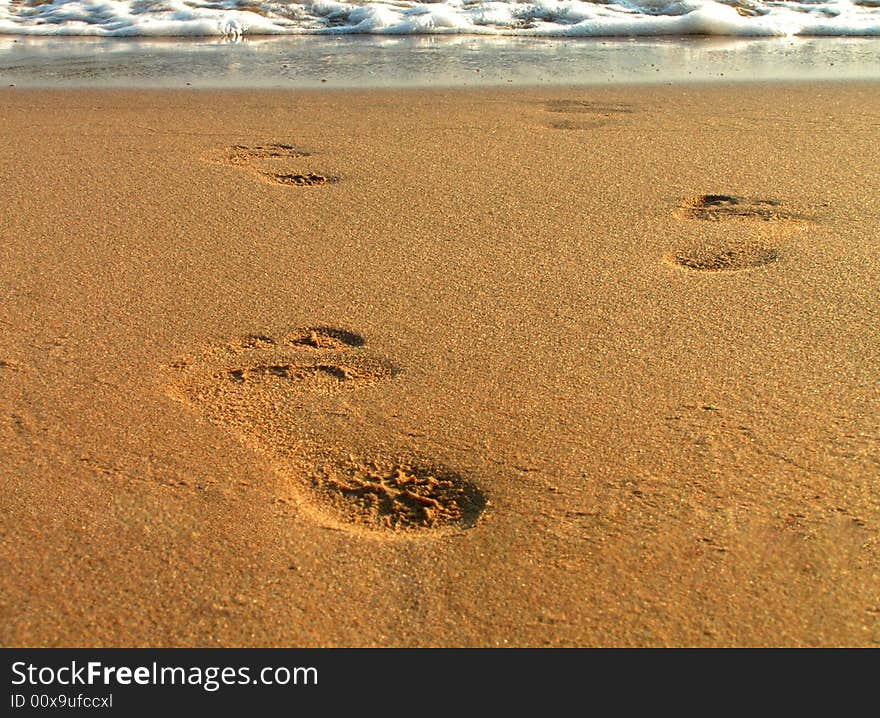 Close up on footsteps on beach