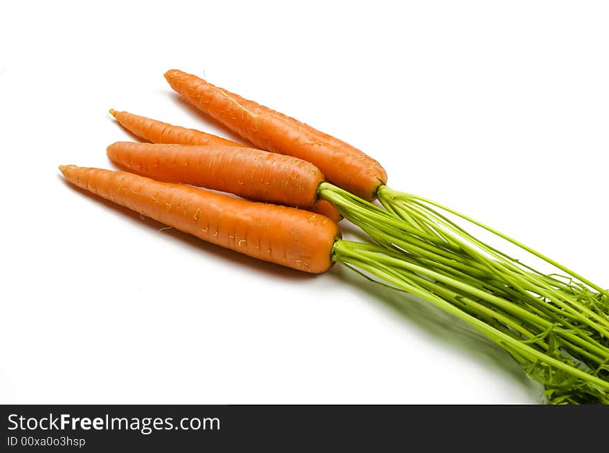 Fresh and ripe bunch of orange carrots isolated on white background. Fresh and ripe bunch of orange carrots isolated on white background