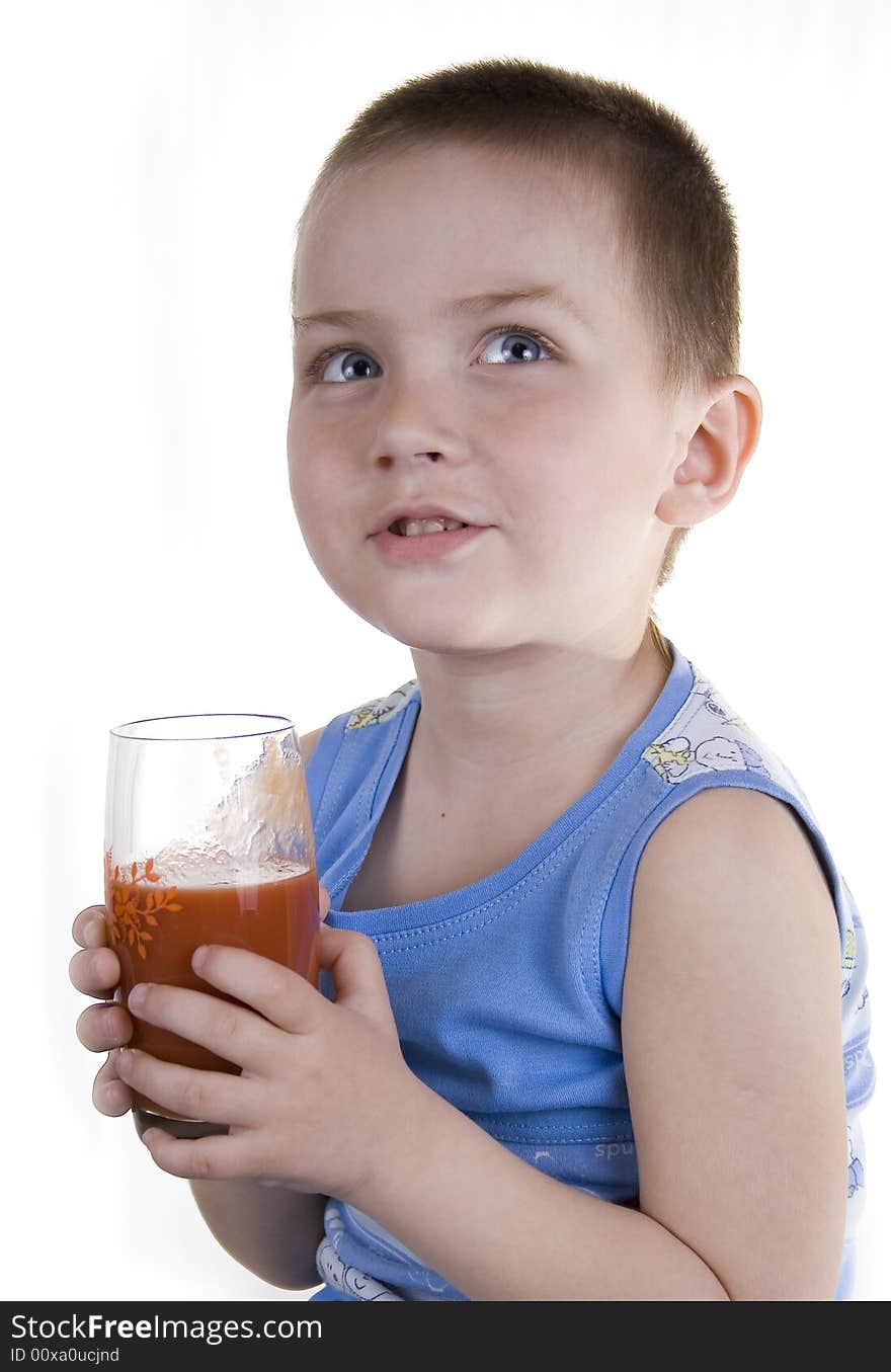 The child drinks tomato juice on a white background