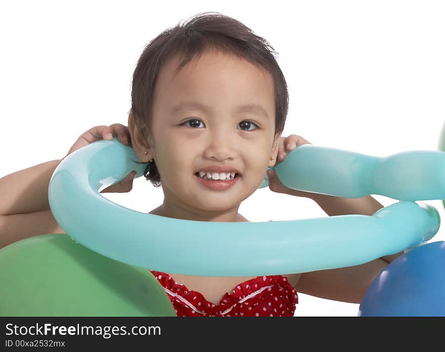 Little child holding balloon on a white background