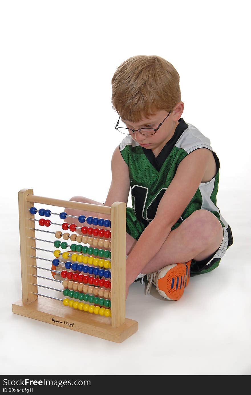 Young boy learning math on an abacus. Young boy learning math on an abacus