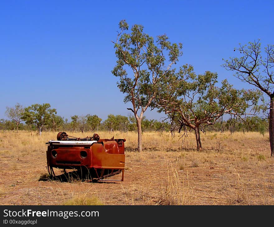 A rusty Volkswagen Type 2 lying upside down in the Outback in Australia. A rusty Volkswagen Type 2 lying upside down in the Outback in Australia