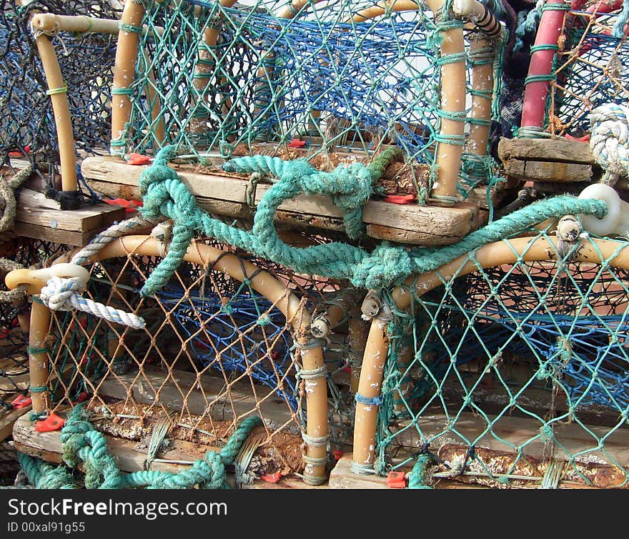 Portrait of some lobster pots seen in detail in harbor.