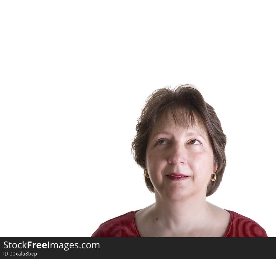 An attractive middle aged woman in red looking up and to the right into copy space. An attractive middle aged woman in red looking up and to the right into copy space