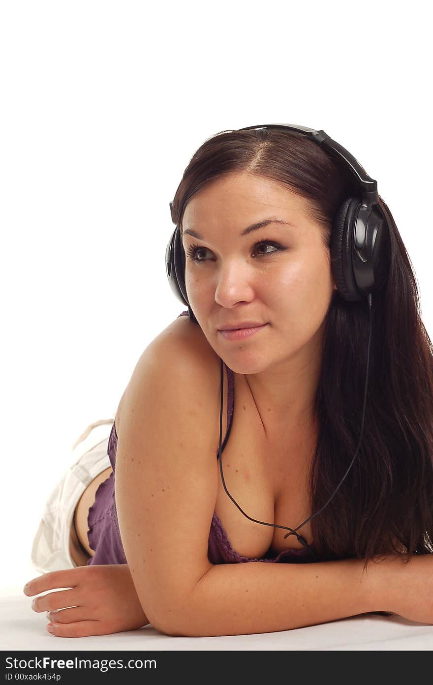 Attractive woman lying with headphones. Attractive woman lying with headphones