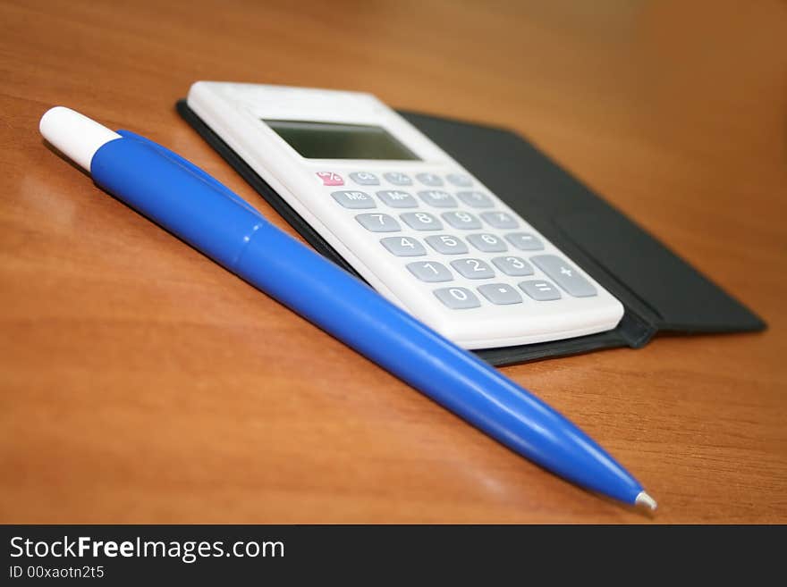 Blue pen and calculator