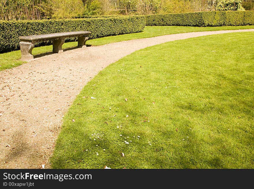 Bench and footpath in romantic garden