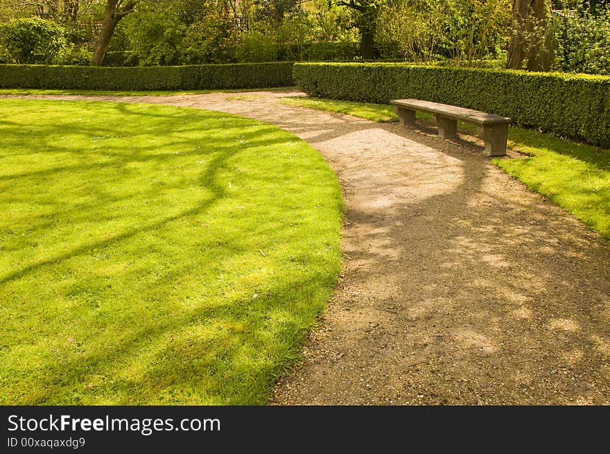 Bench and footpath in romantic garden