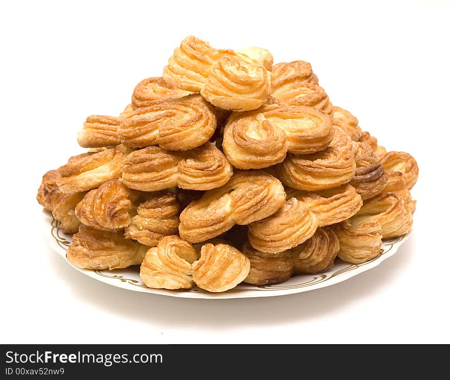 A heap of fresh baked sugar buns on a plate. A heap of fresh baked sugar buns on a plate