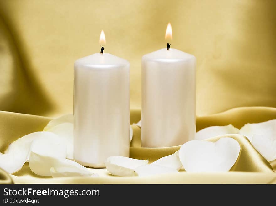 Candles with flower on golden background