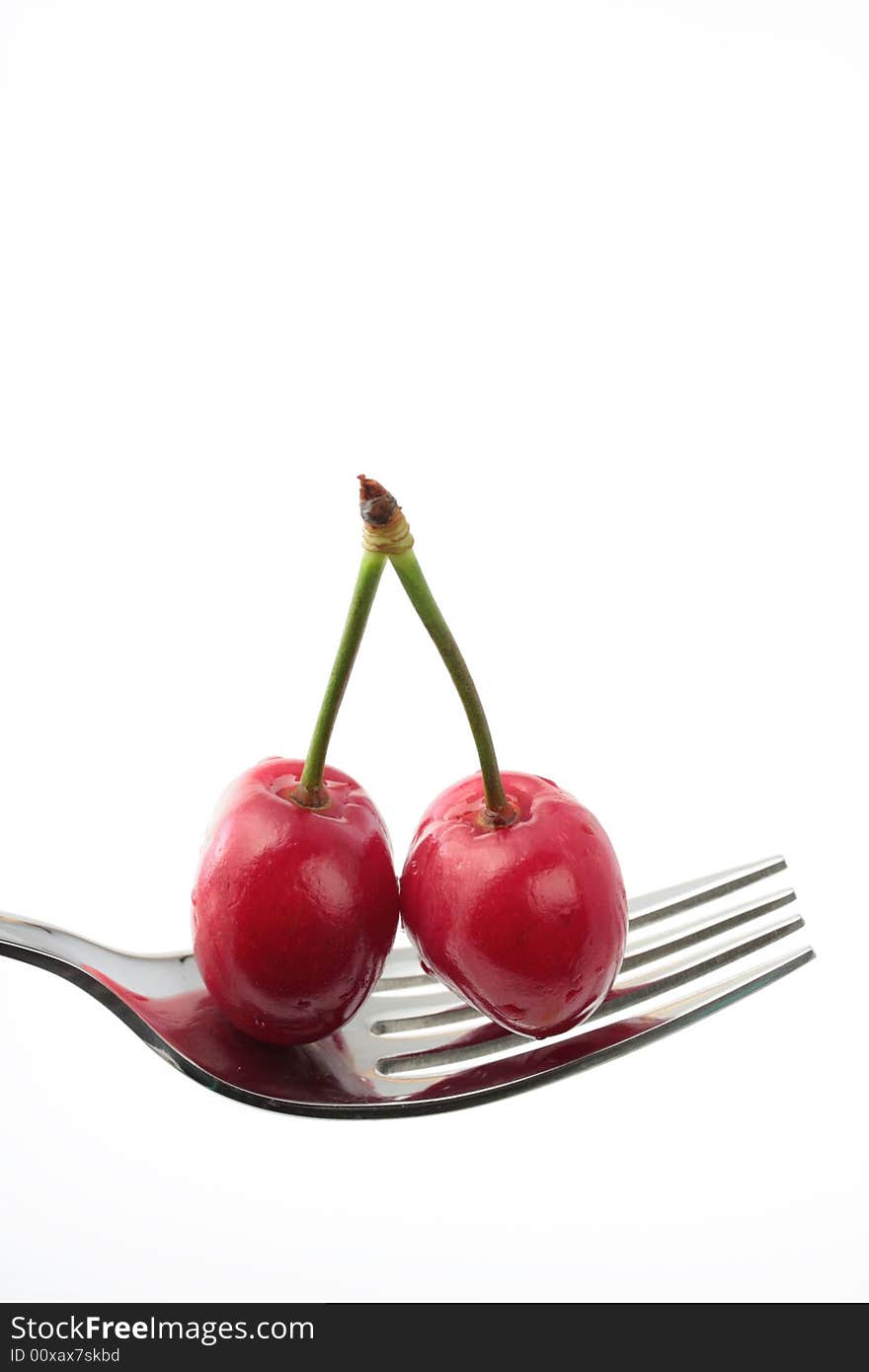 Two cherries on a fork