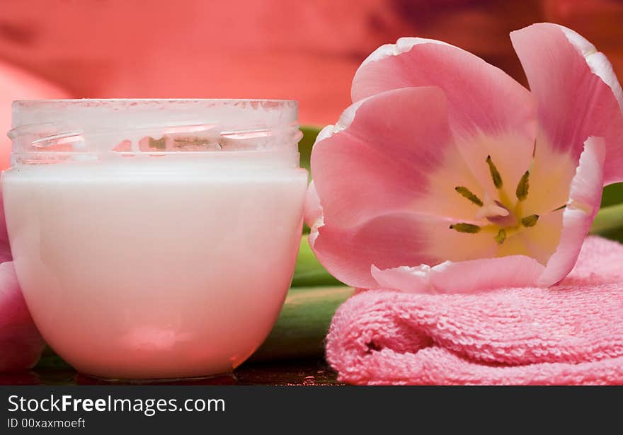 Cream, towel with flowers on red background