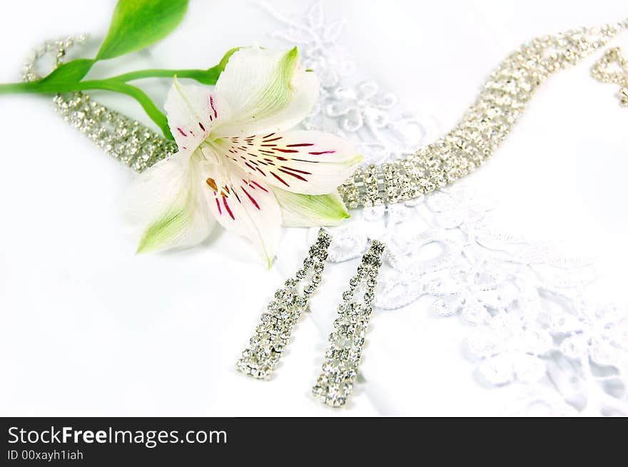 Wedding jewelery, laces, earrings and white flower. Wedding jewelery, laces, earrings and white flower