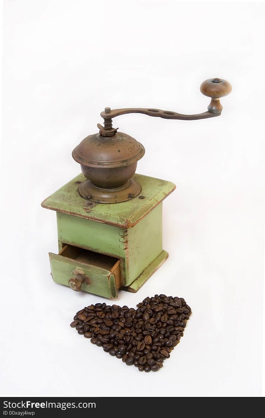 Old coffee grinder with coffee beans isolated