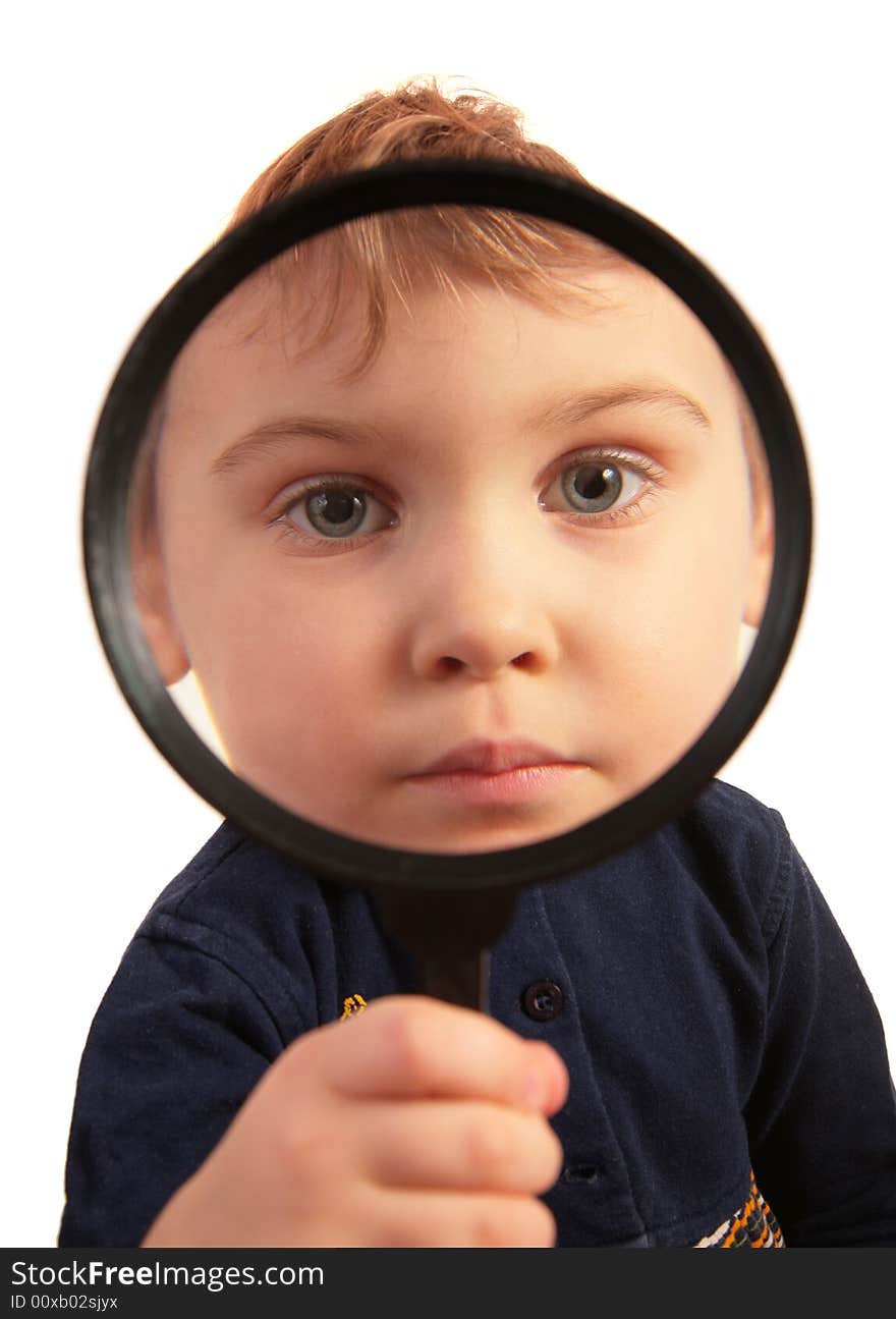 Child look through magnifier on white