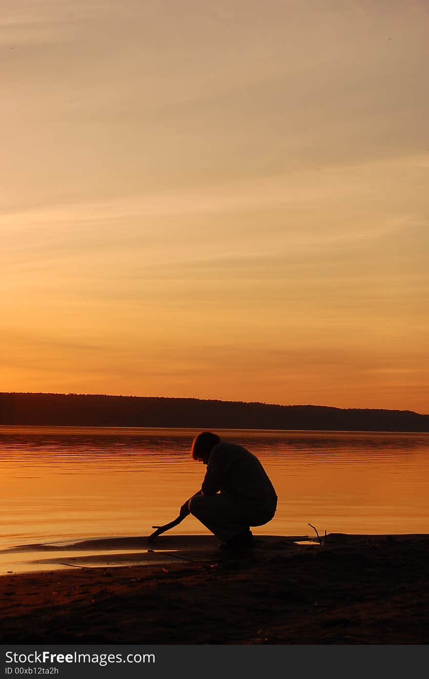 Young man on beach at sunset