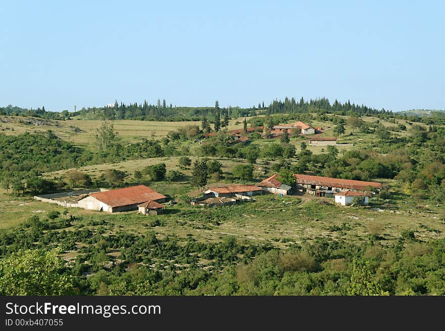 A rural landscape, rustic houses in green environment under blue sky, anatolia, turkey. A rural landscape, rustic houses in green environment under blue sky, anatolia, turkey