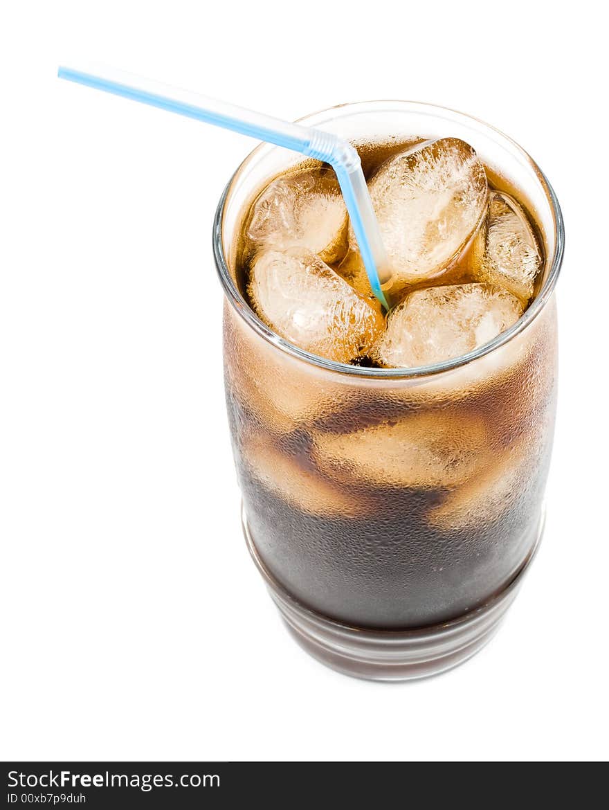 Cold fizzy cola with ice in a glass. Close up.