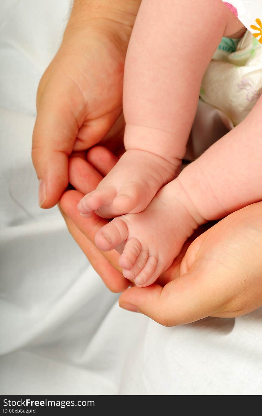 Feet of a young baby in dads hand. Feet of a young baby in dads hand