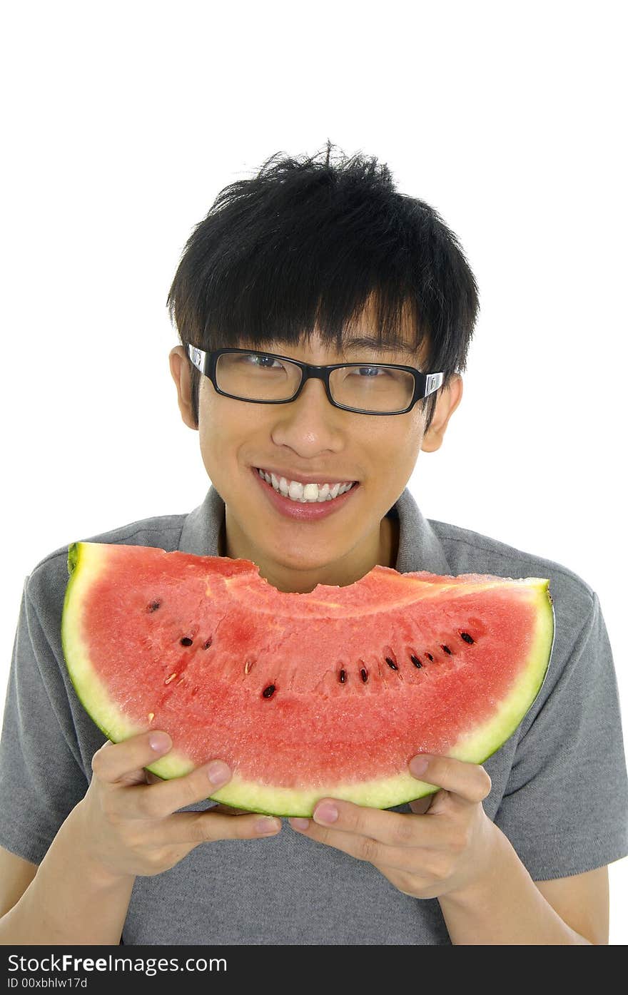 Young Asian boy eating fruit