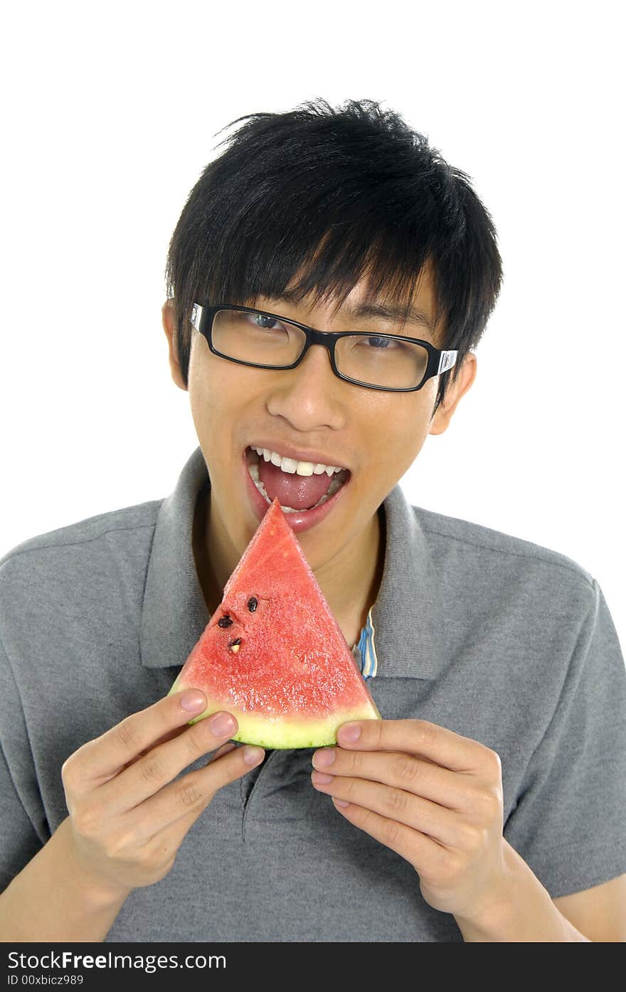 Young Asian boy eating fruit