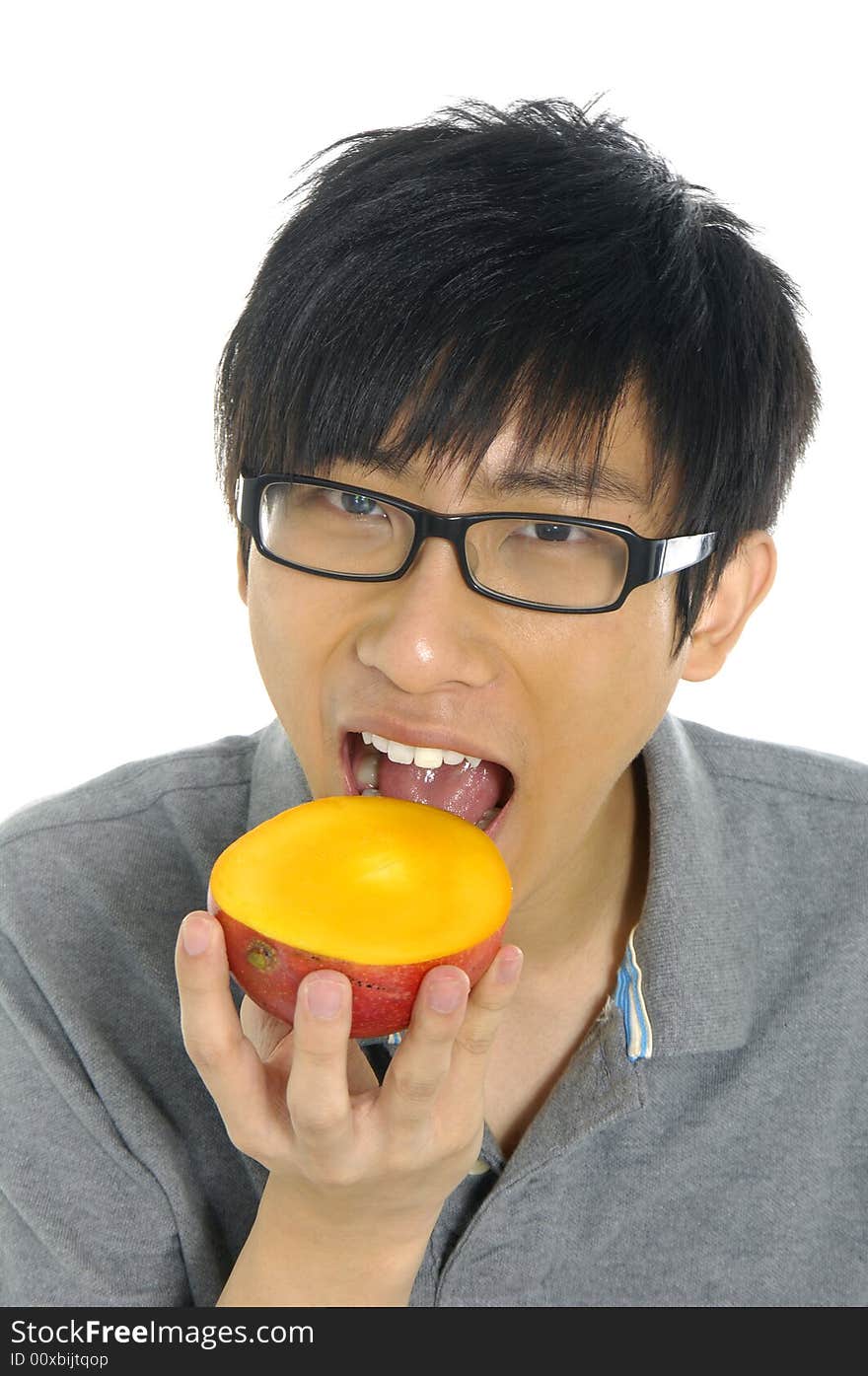 Young Asian boy eating fruit