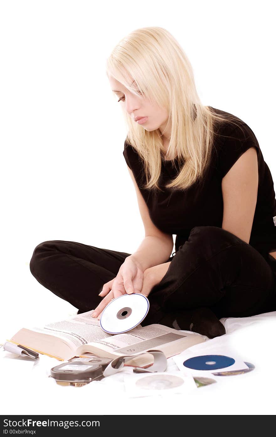 Lovely blonde with hardware reading a book over white. Lovely blonde with hardware reading a book over white