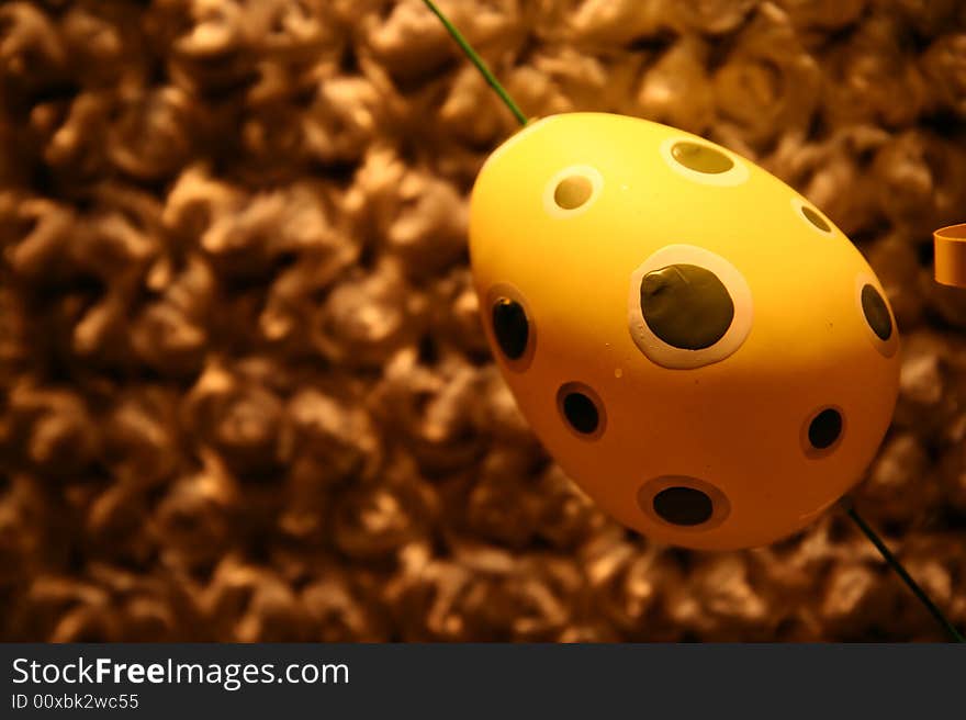 A yellow egg over a brown background