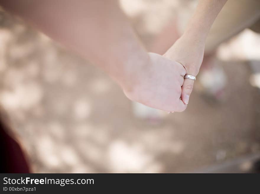 Young woman and young man are holding hands in love outside