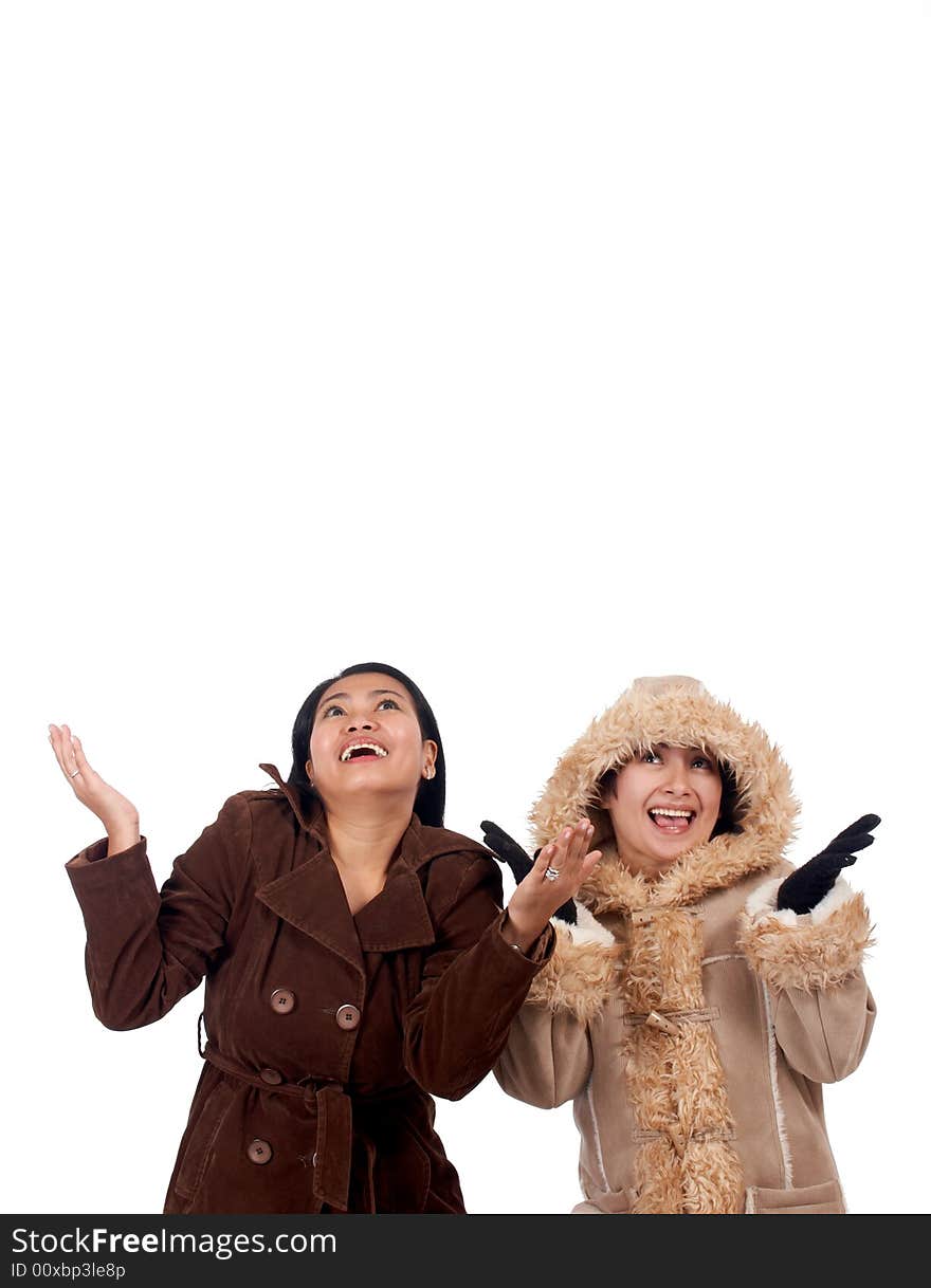 Women in wintercoat trying to catch something