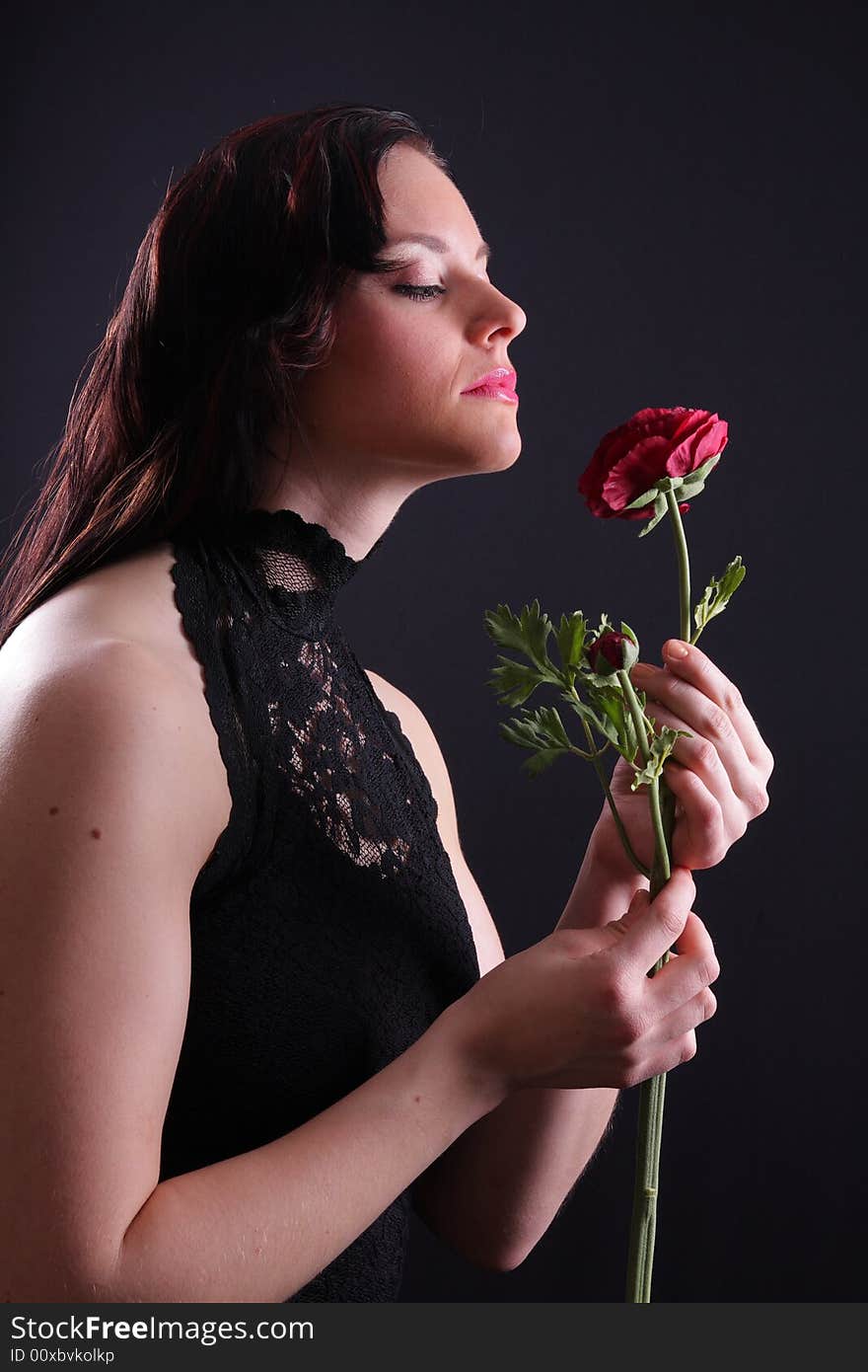 Young woman dressed in black holding a rose. Young woman dressed in black holding a rose