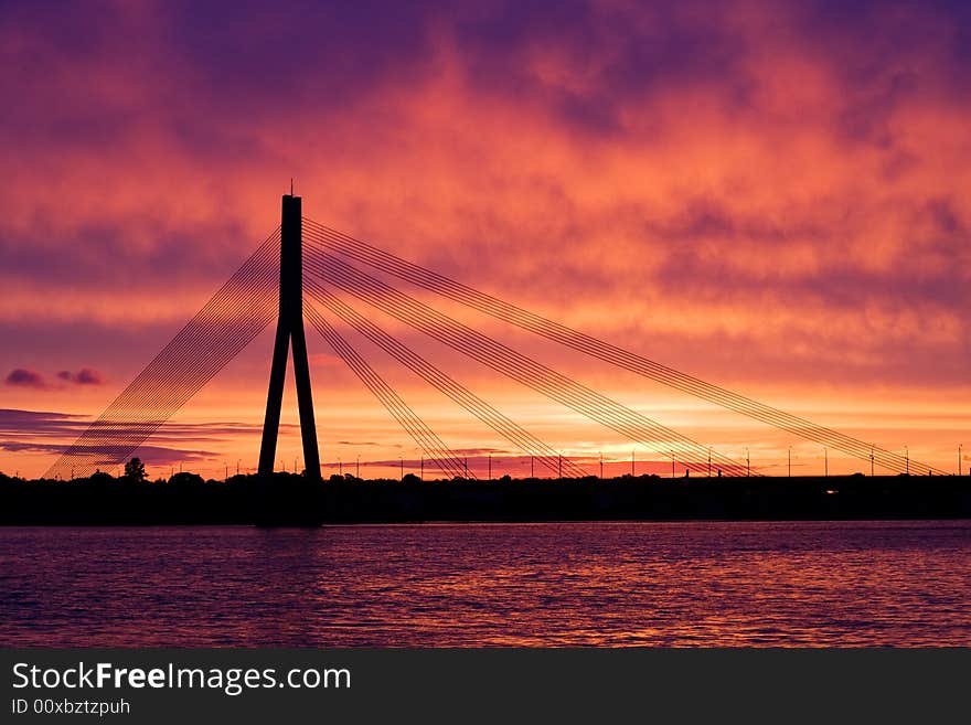 Suspension bridge in Riga, Latvia against sunset sky