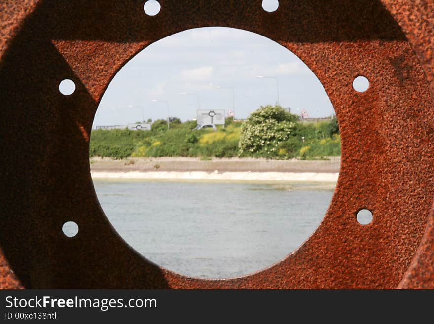 Looking through a rusty porthole with the center with a Sharp DOF Cose up. Looking through a rusty porthole with the center with a Sharp DOF Cose up