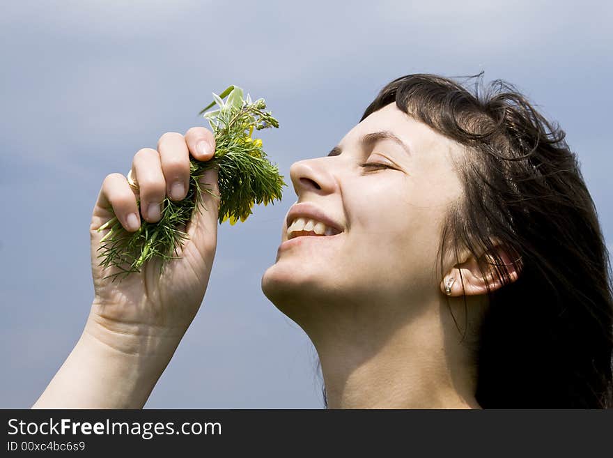 Young girl smelling wild flowers. Young girl smelling wild flowers