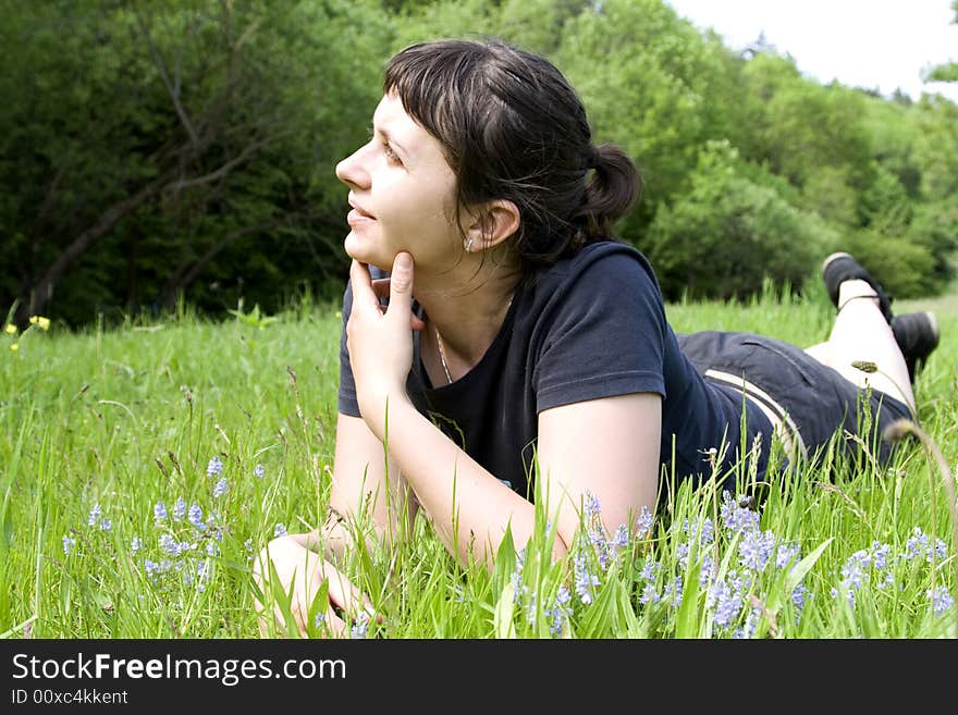 Young girl laying in grass