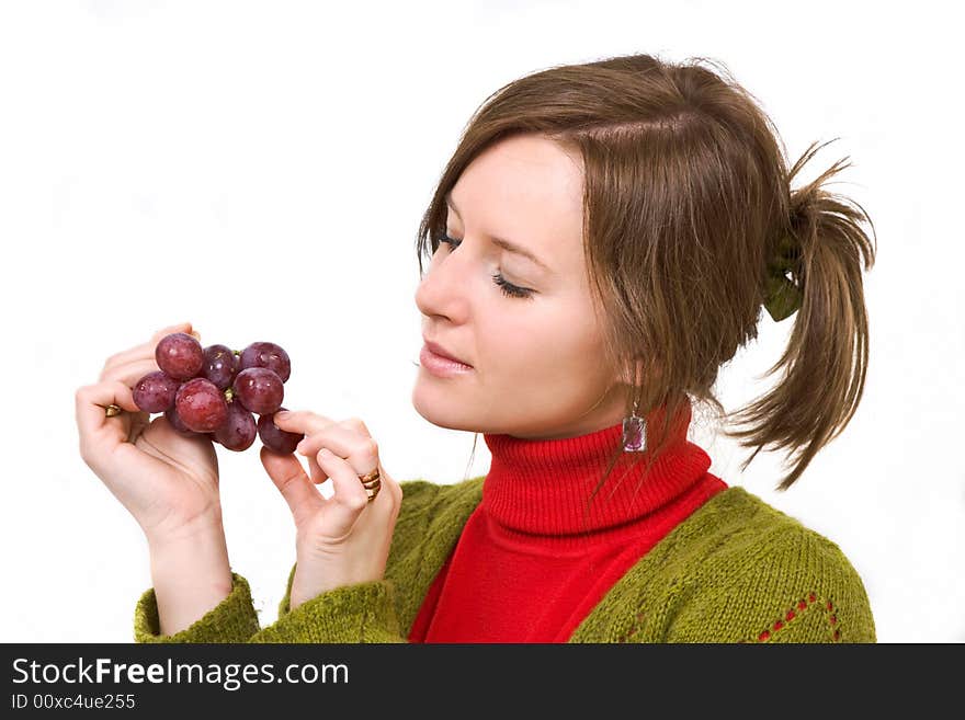 Young girl is holding grapes in the palm