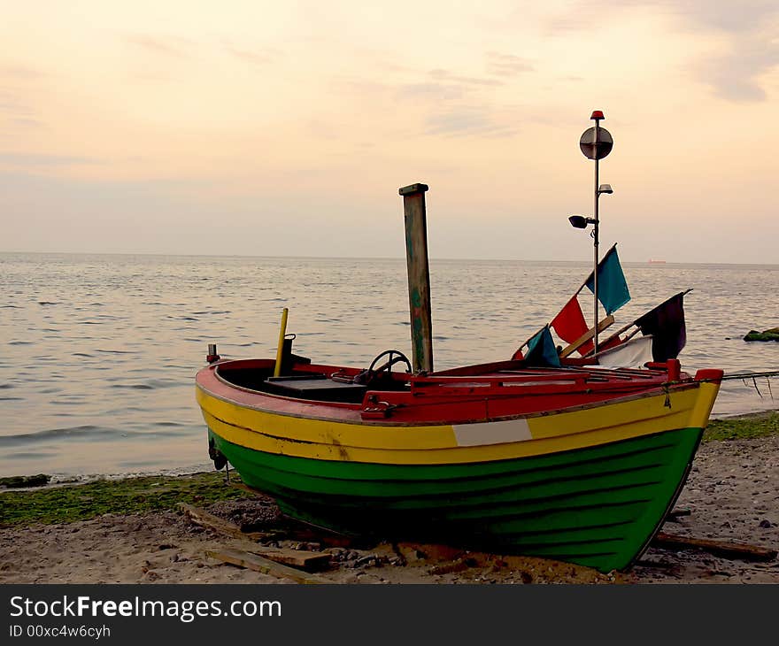 Fishing boat on the bank of the Baltic sea, after work.