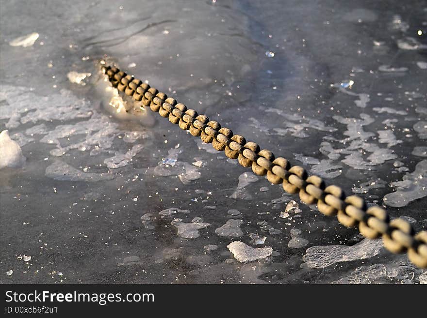 A chain breaking out of a frozen river. A chain breaking out of a frozen river