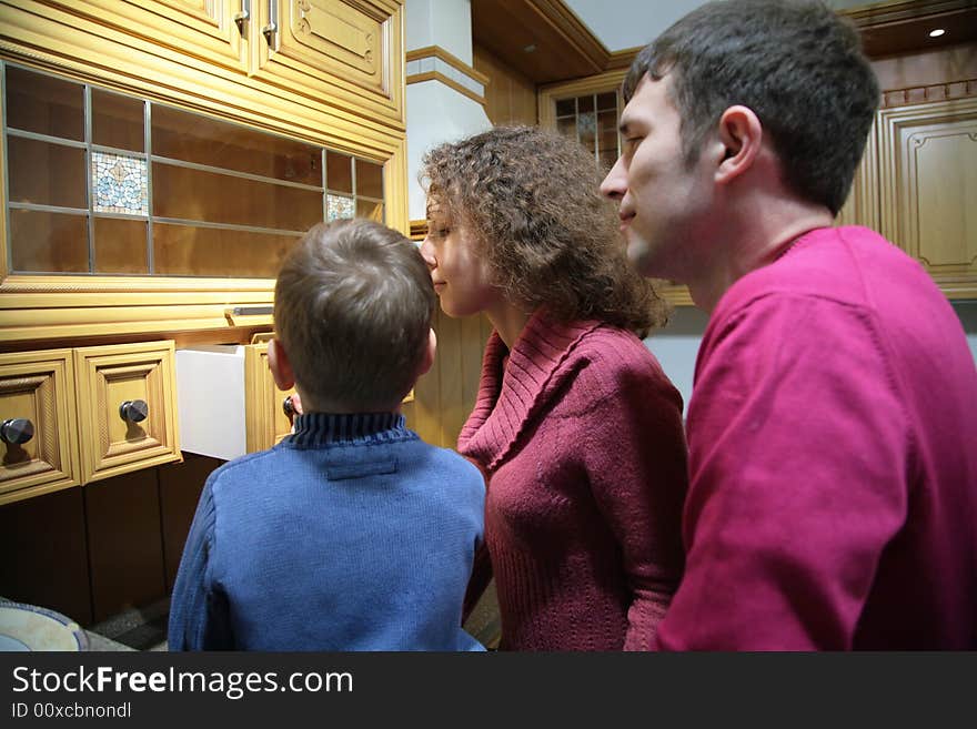 Family in kitchen. Look into box.