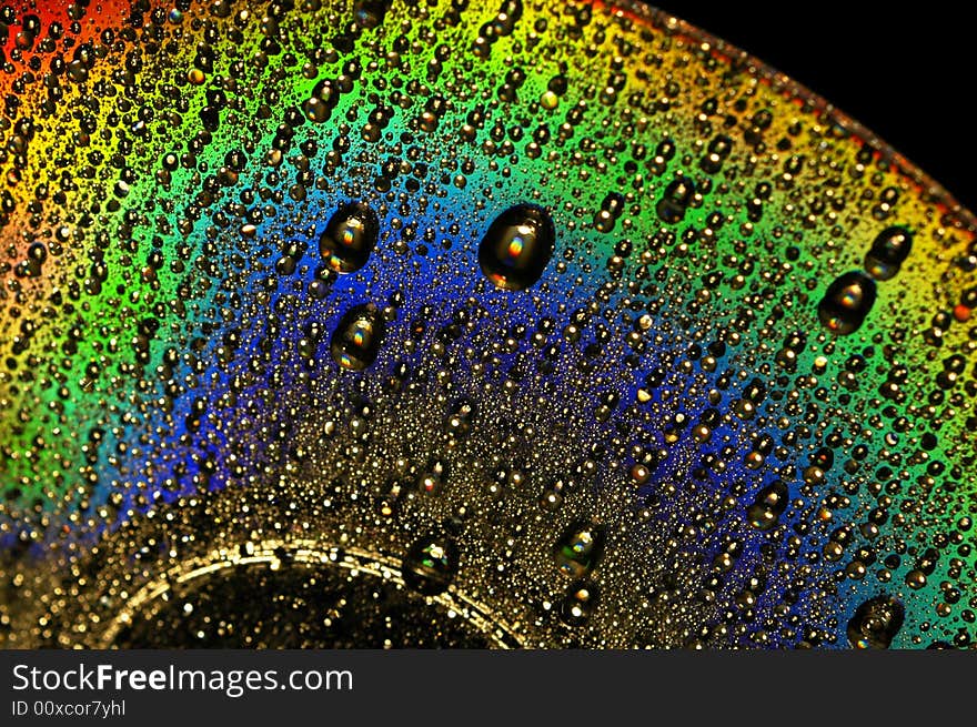 Abstract view of CD covered with water drops. Abstract view of CD covered with water drops