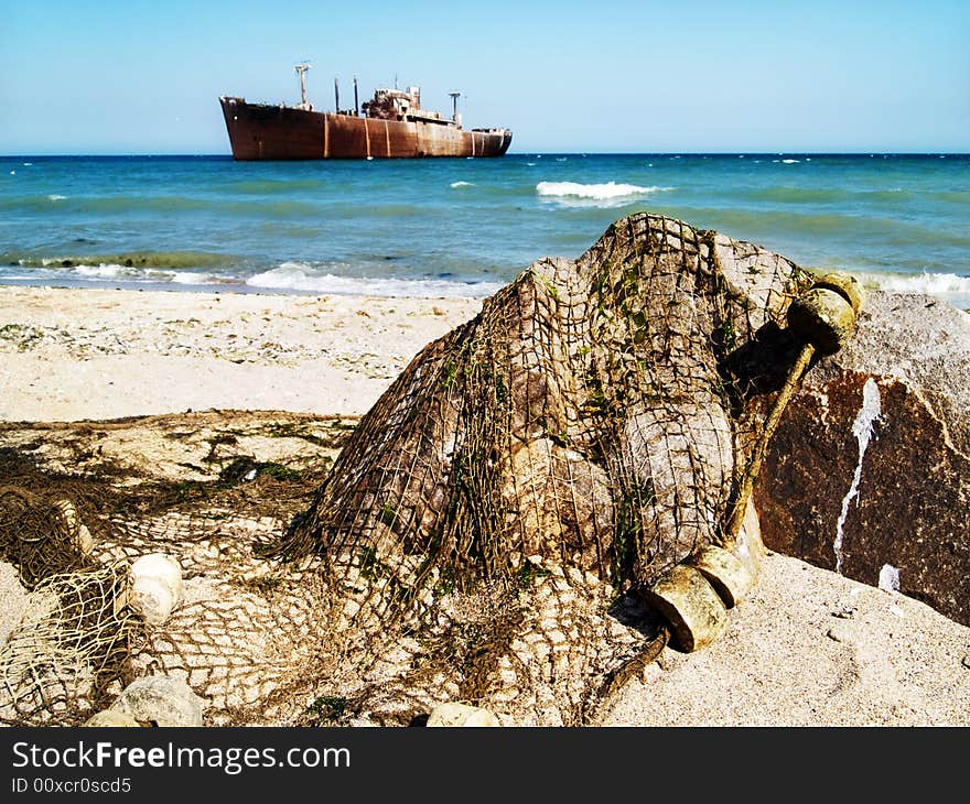 Ship wreck and fishing net on a rock