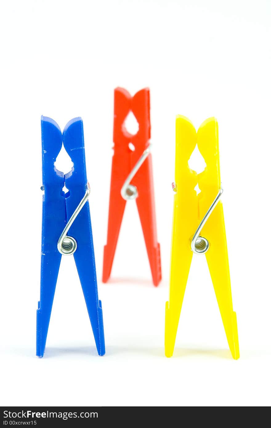 Coloured pegs on white background for hanging. Coloured pegs on white background for hanging