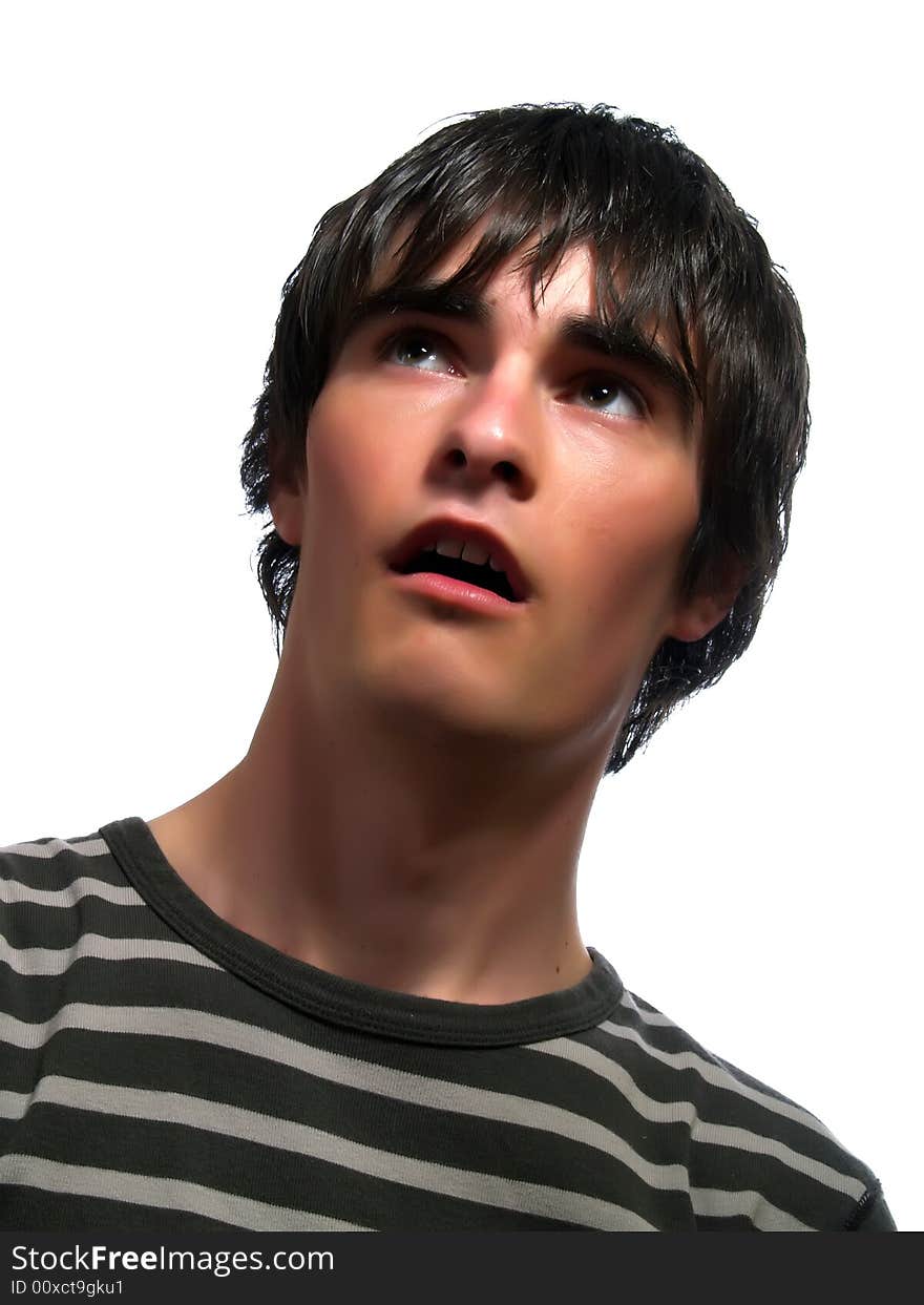 A portrait about a trendy cute young man who is looking up and he is surprised. He is wearing a striped t-shirt. A portrait about a trendy cute young man who is looking up and he is surprised. He is wearing a striped t-shirt.