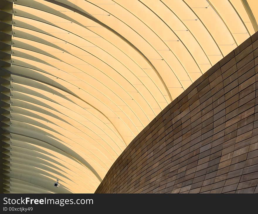 Abstract of metal arches and wood tiled wall in the morning light. Abstract of metal arches and wood tiled wall in the morning light