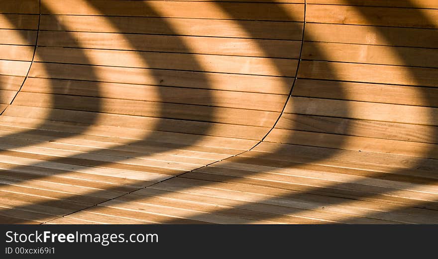 Abstract created by light and shadows on a curve wood-tiled surface. Abstract created by light and shadows on a curve wood-tiled surface