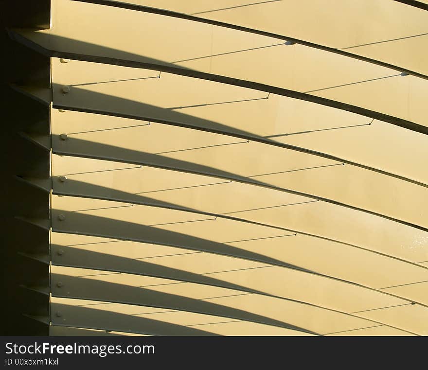 Series of metal arches casting shadows on themselves in the morning light