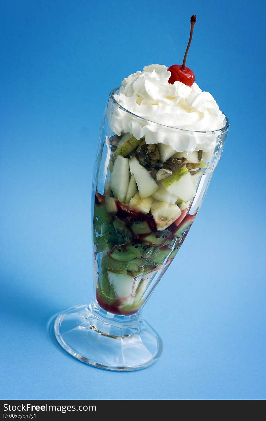 Fruit salad with cream and cherry. Fruit salad with cream and cherry.